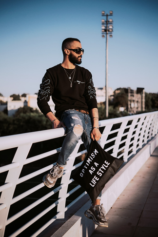 cool guy wearing his training sneakers with ripped jeans