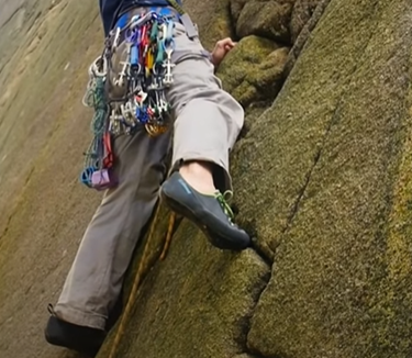 trad climbing by jamming lace climbing shoes in cracks